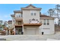 Home features a multi-level deck with a garage underneath and mature trees surrounding the property at 5141 Dixie Lake Rd, Union City, GA 30291