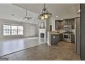 Spacious living room with fireplace, ceiling fan, and views into the kitchen with stainless appliances at 140 Pecan Ridge Dr, Fayetteville, GA 30215