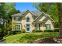 Stunning two-story home featuring a bright blue front door and manicured landscaping at 102 Santolina Park, Peachtree City, GA 30269