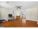 Spacious living room with hardwood floors, a ceiling fan, and plenty of natural light at 195 Riverbend Dr, Covington, GA 30014