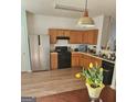 Kitchen featuring stainless steel refrigerator and wooden cabinets at 6806 Blackstone Pl # 12, Mableton, GA 30126