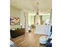 Bright living room with hardwood floors and modern lighting fixture adjacent to dining area at 6806 Blackstone Pl # 12, Mableton, GA 30126