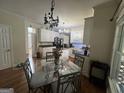 Bright kitchen featuring white cabinets, granite countertops, stainless steel appliances, and hardwood floors adjacent to the dining area at 750 Gates Ln, Alpharetta, GA 30022