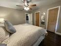 Cozy bedroom with neutral walls, ceiling fan, and paneled doors at 727 Channing Dr, Atlanta, GA 30318