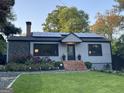 Inviting home showcasing brick steps, stone and gray shingle accents, and modern solar panels at 727 Channing Dr, Atlanta, GA 30318