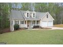 Charming home with well-manicured lawn, two-car garage, and inviting front porch at 6435 Philips Creek Dr, Cumming, GA 30041