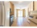 A bright and functional kitchen featuring tile flooring, ample counter space, and an adjacent dining area at 6844 Saganaw Dr, Rex, GA 30273