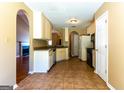 An open kitchen featuring tile flooring and a view into the living space at 6844 Saganaw Dr, Rex, GA 30273