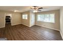 Open-concept living area boasts updated flooring, natural light, and a view of the kitchen at 1089 Canal St, Decatur, GA 30032