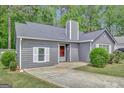 Traditional one story home featuring a gray exterior, shingled roof, and well-maintained lawn at 322 Wood Rdg, Peachtree City, GA 30269