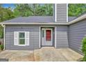 Inviting one story house with a gray facade, white trim, and a red front door at 322 Wood Rdg, Peachtree City, GA 30269