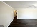 Bright living room featuring fresh paint, modern dark-stained flooring, and ample natural light at 2361 Whites Mill Rd, Decatur, GA 30032