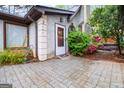 Inviting home entrance with a charming white door, decorative columns, and beautiful surrounding plants at 5082 Highland Hills Ct # 93, Stone Mountain, GA 30088