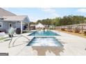 Backyard includes a luxurious in-ground pool and spa perfect for entertaining at 155 Lawrence Dr, Villa Rica, GA 30180