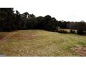 A tranquil green field sits on a quiet property surrounded by mature trees at 5300 Salem Rd, Covington, GA 30016