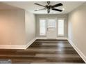 Inviting living room space with wood floors, modern ceiling fan, and bright lighting at 3456 Glensford Dr, Decatur, GA 30032