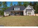 Beautiful home with well-manicured lawn, neutral paint scheme and a cozy front porch at 115 W Wind Ct, Tyrone, GA 30290