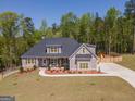Expansive home exterior with lush lawn, fenced yard, and ample parking for the whole Gathering at 115 W Wind Ct, Tyrone, GA 30290