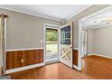 Inviting foyer with hardwood floors, wood-paneled walls, and a charming stained-glass front door at 324 County Line Rd, Fayetteville, GA 30215