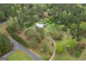 An aerial view showcasing a property with mature trees, spacious yard, and circular driveway at 24 Shiloh Church Rd, Carrollton, GA 30116