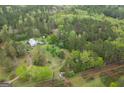 Overhead shot of a house surrounded by dense, mature trees, providing privacy and a natural setting at 24 Shiloh Church Rd, Carrollton, GA 30116