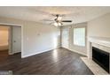 Inviting living room with a fireplace, wood-look floors, and natural light at 825 Rapid Ct, Mcdonough, GA 30252