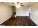 Bright living room with modern wood flooring and stairs leading to the second floor at 825 Rapid Ct, Mcdonough, GA 30252