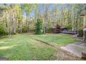 Large backyard with a wooded area, wooden deck and partially enclosed wooden gazebo at 215 North Mourning Dove N Dr, Fayetteville, GA 30215