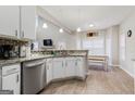 Bright kitchen features white cabinets, granite countertops, and stainless steel appliances at 220 Camerons Way, Covington, GA 30016