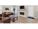 Cozy living room featuring a fireplace, plush sofas, and lots of natural light at 220 Camerons Way, Covington, GA 30016