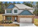 Beautiful two-story residence featuring a brick and siding exterior, a two-car garage, and a well-kept front yard at 1011 Austin Rd, Ellenwood, GA 30294
