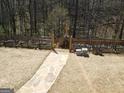 Fenced garden with stone walkway and raised planters at 1007 Oglethorpe Ct, Woodstock, GA 30188
