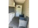 Covered front porch with chairs and a white door with a decorative window at 9503 Winding Way Ln, Jonesboro, GA 30238