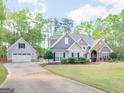 Beautiful craftsman-style home with lush landscaping, attached garage, and long driveway at 225 Suffolk Way, Mcdonough, GA 30252