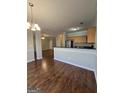 Open concept dining area and kitchen featuring modern appliances, hardwood floors, and ample counter space at 403 Buckboard Ln, Locust Grove, GA 30248