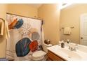 Well-lit bathroom features a decorative shower curtain, white fixtures, and clean, modern design elements at 6089 Indian Wood Se Cir, Mableton, GA 30126