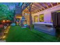 Cozy backyard with a hot tub, artificial turf, and a hanging chair for outdoor relaxation at 3028 Pruitt Ln, Smyrna, GA 30080