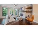 Cozy living room featuring a fireplace, hardwood floors, and access to an outdoor deck at 3028 Pruitt Ln, Smyrna, GA 30080