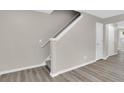 Bright staircase leads to the upper level, with laminate floors and natural light in the background at 1372 Hollenbeck Ln, Riverdale, GA 30296