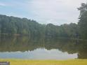 Scenic view of a tranquil lake surrounded by lush greenery at 2467 Highway 138 Sw, Conyers, GA 30094