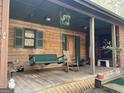 Inviting front porch with swing, rocking chair, and decorative hanging plant at 2467 Highway 138 Sw, Conyers, GA 30094