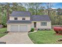 Inviting two-story home with a two-car garage, front lawn, and manicured greenery at 106 Gateway Pt, Peachtree City, GA 30269