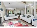 Bright living room with vaulted ceiling, wood floors, fireplace, and open staircase at 675 Granby Hill Pl, Alpharetta, GA 30022