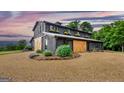 Striking barn conversion with rustic wood siding, garden boxes, and gravel driveway at 238 Indian Creek Rd, Locust Grove, GA 30248