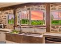 Charming kitchen with stone sink, wood accents, and serene outdoor views at 238 Indian Creek Rd, Locust Grove, GA 30248