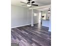 Bright and airy living room featuring sleek, modern flooring and a ceiling fan at 6505 Allatoona Rd, Morrow, GA 30260