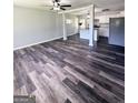 Spacious living room with stylish flooring, ceiling fan, and an open layout to the kitchen at 6505 Allatoona Rd, Morrow, GA 30260