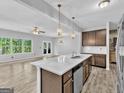 Bright, open kitchen with quartz countertops, stainless steel appliances, and views of the living area at 488 Jefferson Chase St, Atlanta, GA 30354