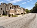 Street view of townhomes in a well-maintained neighborhood with sidewalks and landscaping at 488 Jefferson Chase St, Atlanta, GA 30354