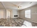Bright and airy living area featuring stylish floors, a contemporary fireplace, and large window at 36 Highpoint Ln, Locust Grove, GA 30248
